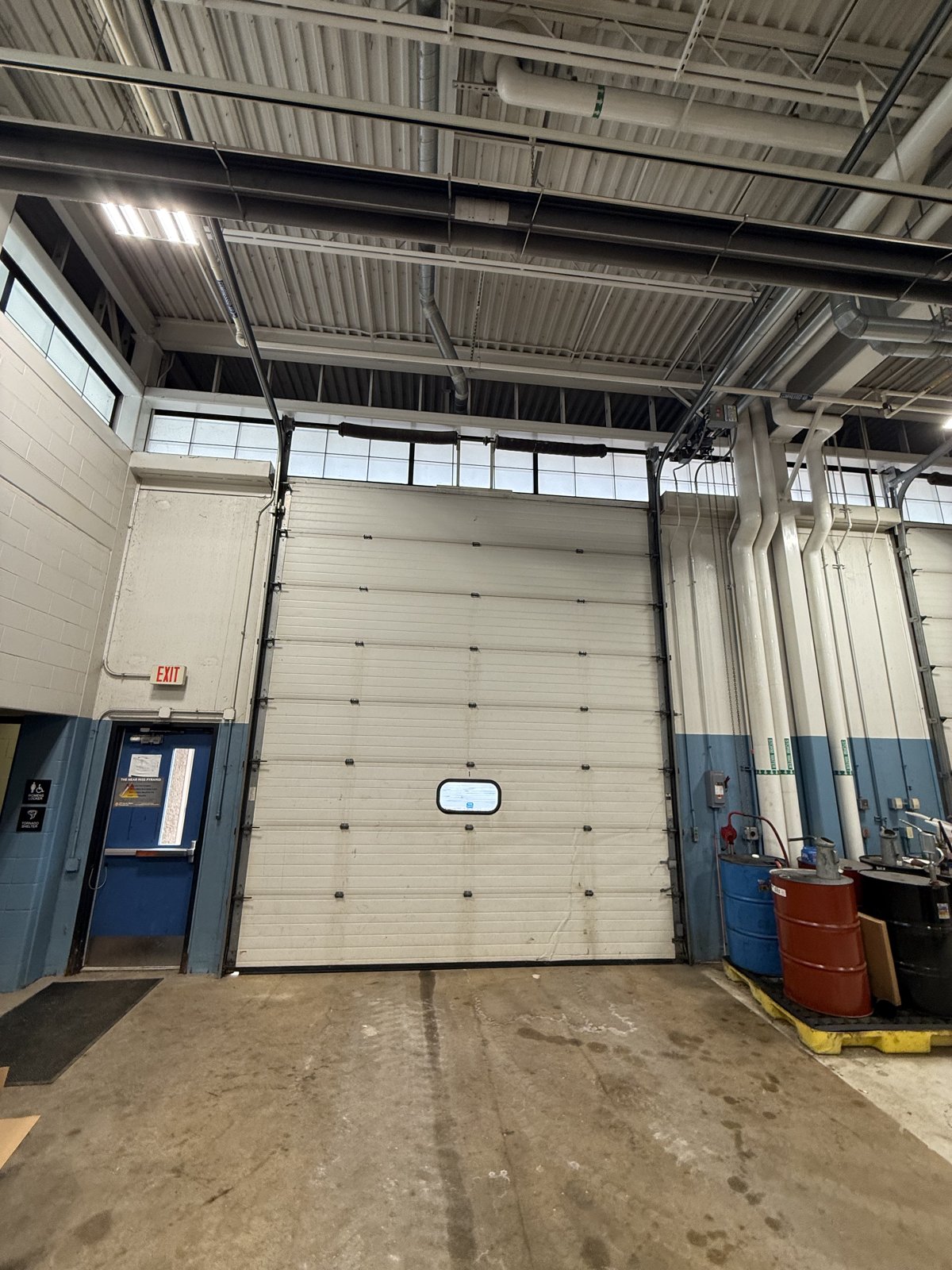 Commercial sectional overhead door in a warehouse Insulated sectional overhead door inside a commercial service bay