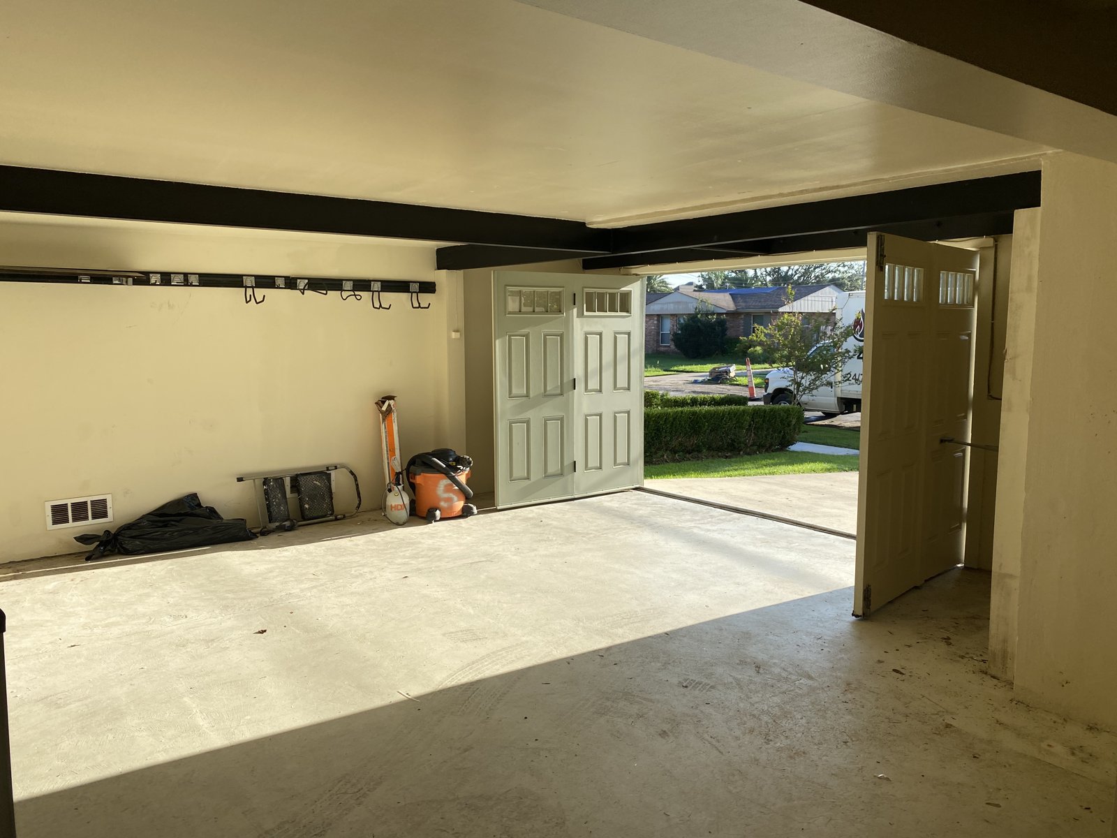 Finished garage interior with carriage doors Finished garage interior with painted walls, open carriage doors and a clean floor