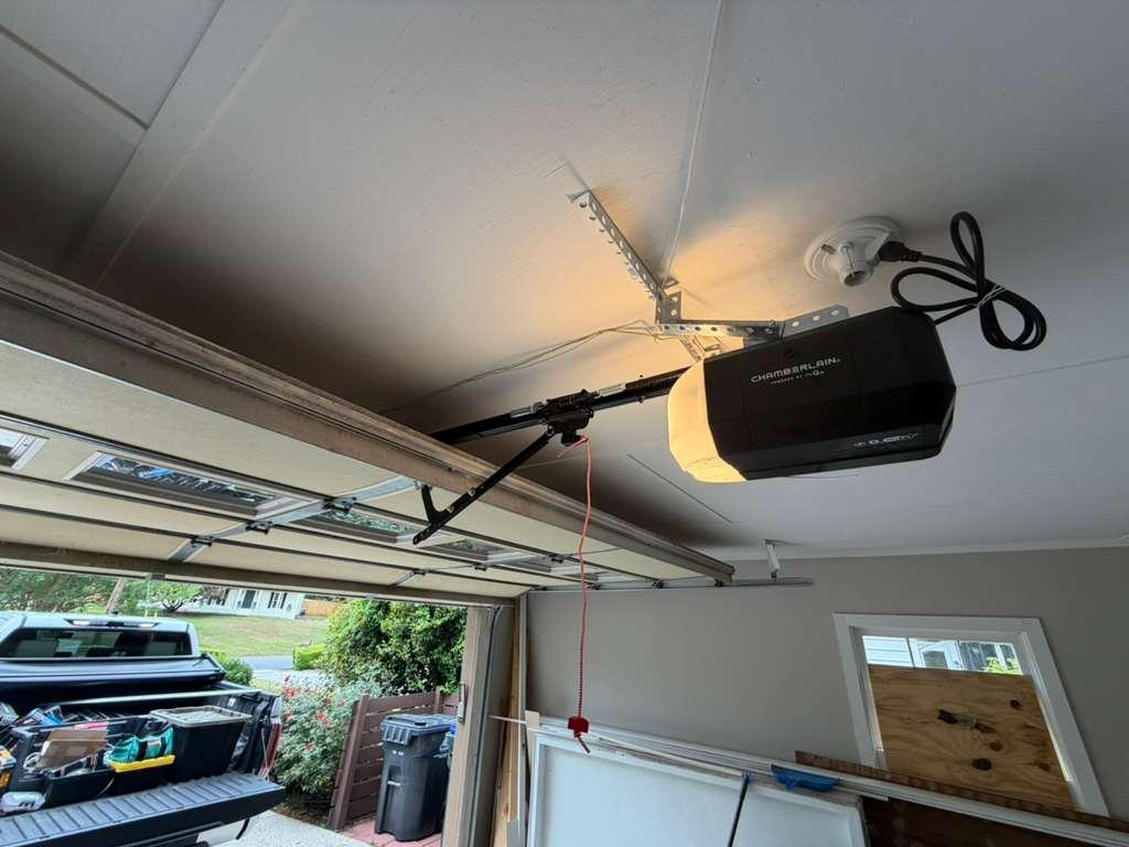 Chamberlain garage door opener installation in Canton, GA New Chamberlain belt-drive garage door opener mounted to the ceiling with a fresh rail in Canton, GA