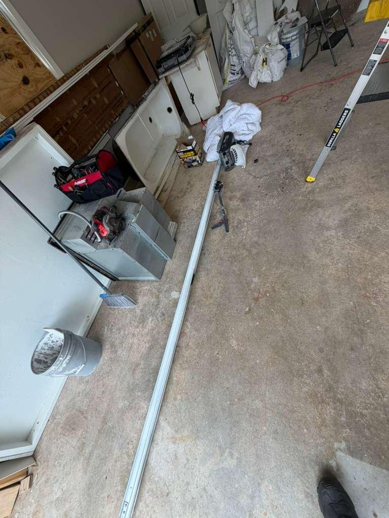 Garage door opener rail installation in Woodstock, GA New garage door opener rail laid out on the garage floor before installation in Woodstock, GA