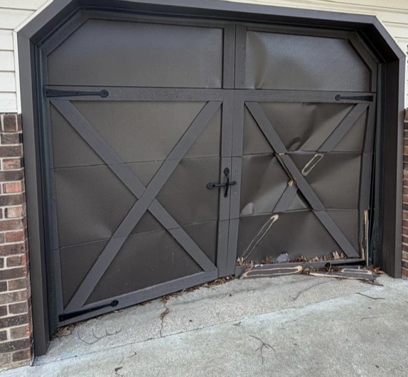 Brown carriage-style garage door repair — before